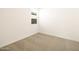 Bright bedroom with neutral carpet, a window, and ample natural light at 17409 W Eva St, Waddell, AZ 85355