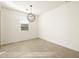 Bright dining room featuring a modern chandelier and natural light from the window at 17409 W Eva St, Waddell, AZ 85355