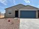 Charming single-story home with a two-car garage, well-maintained landscaping, and a welcoming facade at 17409 W Eva St, Waddell, AZ 85355