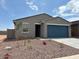 Charming single-story home with a two-car garage, well-maintained landscaping, and a welcoming facade at 17409 W Eva St, Waddell, AZ 85355