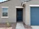 Close-up of a house's front entry, featuring a blue door and window at 17409 W Eva St, Waddell, AZ 85355