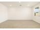 Bright and spacious living room with tile flooring and a large window for natural light at 17409 W Eva St, Waddell, AZ 85355