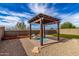 Backyard showcasing an elaborate pergola, rock landscaping and artificial turf at 17532 W Copper Ridge Dr, Goodyear, AZ 85338