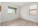 Bright, empty bedroom showcasing neutral tile flooring and a window with natural light at 17532 W Copper Ridge Dr, Goodyear, AZ 85338