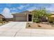 Charming single-story home with a two car garage, desert landscaping, and a welcoming front entrance at 17532 W Copper Ridge Dr, Goodyear, AZ 85338