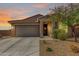 Charming single-story home with a two car garage, desert landscaping, and a welcoming front entrance at 17532 W Copper Ridge Dr, Goodyear, AZ 85338
