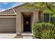 Welcoming front entry with desert landscape, and a decorative wreath on the front door at 17532 W Copper Ridge Dr, Goodyear, AZ 85338