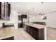 Open kitchen with granite countertops, a stainless steel refrigerator, and a view into the living room at 17532 W Copper Ridge Dr, Goodyear, AZ 85338