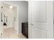 A peek into the laundry room with an alcove and cabinet in front of the entrance at 17532 W Copper Ridge Dr, Goodyear, AZ 85338