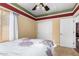 Bedroom features a decorative ceiling, window, and closet with sliding doors at 18171 W Marshall Ln, Surprise, AZ 85388