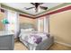Cozy bedroom with a patterned bedspread, a dresser, and neutral-toned walls at 18171 W Marshall Ln, Surprise, AZ 85388