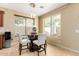 Cozy dining area with a modern chandelier and a view of the outdoor space through the window at 18171 W Marshall Ln, Surprise, AZ 85388