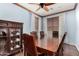 Traditional dining room featuring wood floors, a ceiling fan, and a display cabinet at 18171 W Marshall Ln, Surprise, AZ 85388