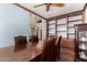 Elegant dining room with a wooden table, leather chairs, and built-in shelving at 18171 W Marshall Ln, Surprise, AZ 85388