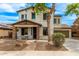 Charming two-story home featuring a stone-accented porch, manicured landscaping, and a welcoming pathway at 18171 W Marshall Ln, Surprise, AZ 85388