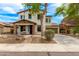 Inviting two-story home with stone accents, a well-maintained yard, and a spacious driveway at 18171 W Marshall Ln, Surprise, AZ 85388