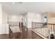 Upstairs hallway featuring wood floors, iron railings and a view of the entry below at 18171 W Marshall Ln, Surprise, AZ 85388