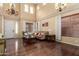Elegant living room featuring hardwood floors, high ceilings, large windows, and stylish furniture at 18171 W Marshall Ln, Surprise, AZ 85388
