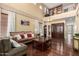 Bright living room with high ceilings, hardwood floors, a decorative staircase and traditional furnishings at 18171 W Marshall Ln, Surprise, AZ 85388