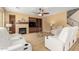 Cozy living room with a fireplace, built-in shelves, and comfortable seating, perfect for relaxation at 18171 W Marshall Ln, Surprise, AZ 85388