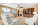 Inviting living room featuring a fireplace, built-in shelving, comfortable seating, and abundant natural light at 18171 W Marshall Ln, Surprise, AZ 85388