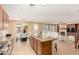 Open kitchen and living area with granite counters, dining space, and a cozy fireplace at 18171 W Marshall Ln, Surprise, AZ 85388