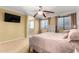 Bedroom showcasing carpeted floors, ceiling fan, and ample natural light at 18171 W Marshall Ln, Surprise, AZ 85388