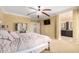 Spacious main bedroom with carpet, ceiling fan, connected bathroom, and neutral paint at 18171 W Marshall Ln, Surprise, AZ 85388