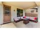 Cozy covered patio seating area with plush cushions, ideal for relaxation and outdoor living at 18171 W Marshall Ln, Surprise, AZ 85388