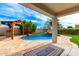 Inviting pool with rock waterfall feature and outdoor living area, perfect for entertaining guests at 18171 W Marshall Ln, Surprise, AZ 85388