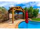 Poolside view of wooden cabana featuring a grill, perfect for outdoor dining and entertainment at 18171 W Marshall Ln, Surprise, AZ 85388