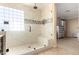 A large shower with glass enclosure and a mosaic tile accent stripe in the bathroom at 18171 W Marshall Ln, Surprise, AZ 85388