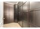 Walk-in closet boasting dark wood cabinets and shelving at 18171 W Marshall Ln, Surprise, AZ 85388