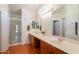 Bright bathroom with walk-in shower, wood floors and dual sink vanity at 1821 N 74Th Pl, Mesa, AZ 85207