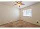 Carpeted bedroom with large window providing natural light at 1821 N 74Th Pl, Mesa, AZ 85207