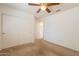 Bedroom with a ceiling fan and a sliding door closet at 1821 N 74Th Pl, Mesa, AZ 85207