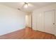 Bedroom with a ceiling fan, laminate floors and closet at 1821 N 74Th Pl, Mesa, AZ 85207