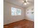 Bedroom featuring laminate wood floors, a fan, and wall shelving at 1821 N 74Th Pl, Mesa, AZ 85207
