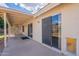 The covered patio has sliding doors and space for outdoor seating and entertainment at 1821 N 74Th Pl, Mesa, AZ 85207