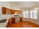 Well-lit kitchen with wood-look floors, white countertops, and stainless steel appliances at 1821 N 74Th Pl, Mesa, AZ 85207