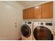 Convenient laundry room equipped with modern washer and dryer units at 1821 N 74Th Pl, Mesa, AZ 85207