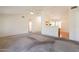 Open-concept living room with neutral carpet and abundant natural light at 1821 N 74Th Pl, Mesa, AZ 85207