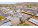Aerial view of a home in the desert with a circular drive and horse property behind it at 19029 E Mary Ann Way, Queen Creek, AZ 85142