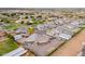 Birds eye view of a grey home with extensive horse property nestled within a quiet residential neighborhood at 19029 E Mary Ann Way, Queen Creek, AZ 85142