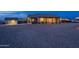 Spacious backyard with an extended covered patio, desert landscaping, and additional storage at 19029 E Mary Ann Way, Queen Creek, AZ 85142