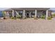 Spacious gravel backyard with a covered patio, desert landscaping, and RV parking at 19029 E Mary Ann Way, Queen Creek, AZ 85142