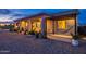 Cozy backyard patio with a hammock, outdoor seating, grill, and lush desert landscaping at 19029 E Mary Ann Way, Queen Creek, AZ 85142