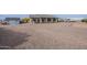 Large gravel backyard featuring a covered patio, desert landscaping, and plenty of space at 19029 E Mary Ann Way, Queen Creek, AZ 85142