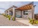 Charming backyard with a covered patio, wooden pergola, a hammock, and lush greenery at 19029 E Mary Ann Way, Queen Creek, AZ 85142