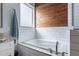This bathroom offers a soaking tub, tile walls, and a modern faucet at 19029 E Mary Ann Way, Queen Creek, AZ 85142